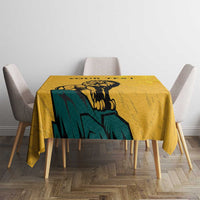 Yellow tablecloth with lion and sun-face design on dining table