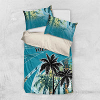 Folded blue bedding set with palm tree design and "YOUR TEXT" print on duvet