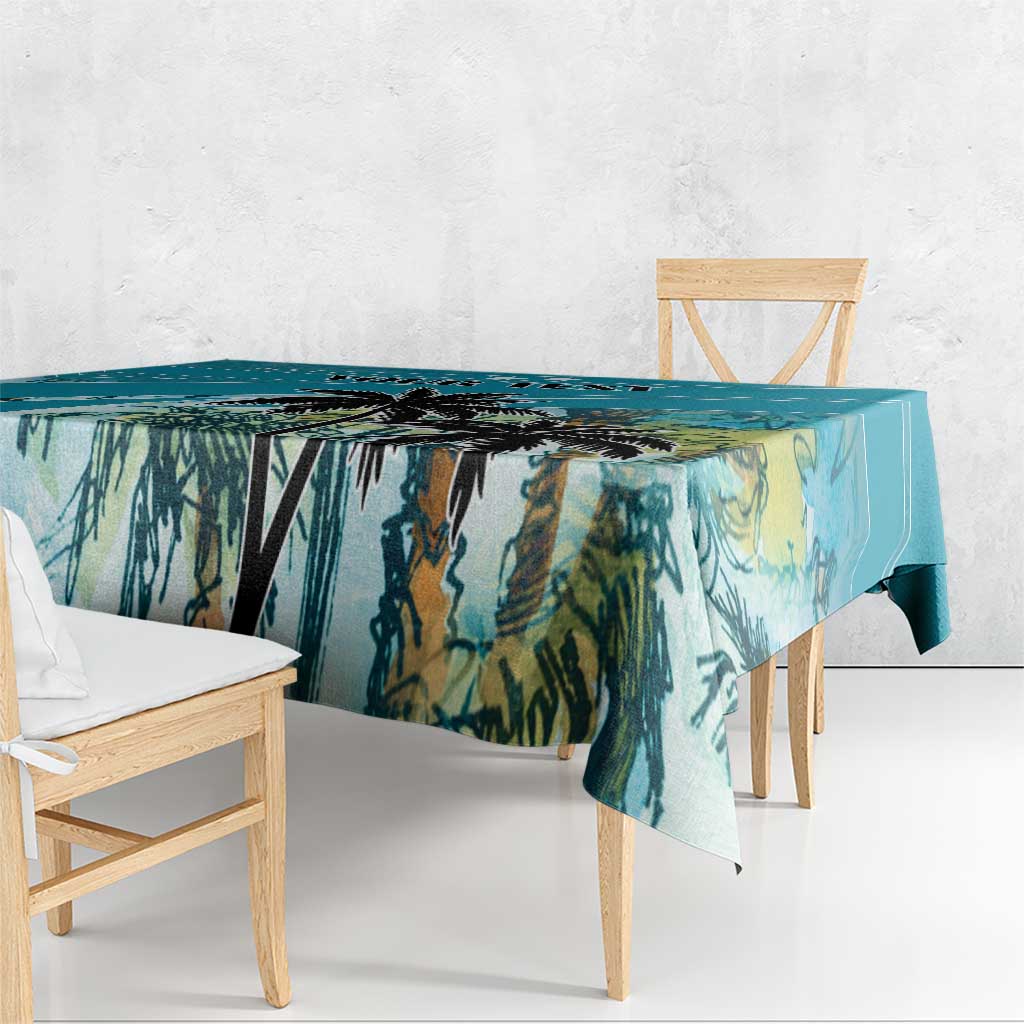 Blue tablecloth with tropical palm leaf print, draped over a rectangular table