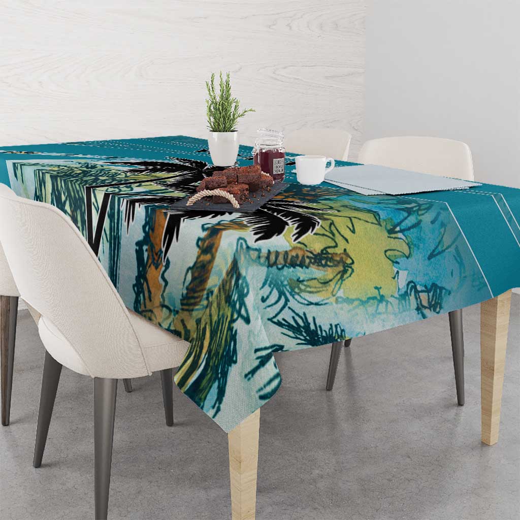 Blue tablecloth with tropical palm leaf print, neatly spread over a dining table