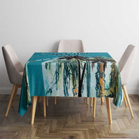 Blue tablecloth with tropical palm leaf print, rectangular cloth on dining table