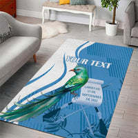 Blue area rug with quetzal bird motif and 'YOUR TEXT' personalized text