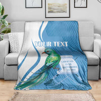 Blue throw blanket featuring quetzal bird and 'YOUR TEXT' title across top