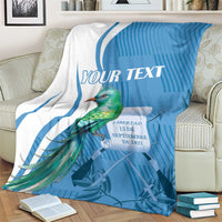 Blue and white throw blanket with quetzal bird design and 'YOUR TEXT' lettering