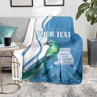 Blue throw blanket with quetzal bird artwork and centered 'YOUR TEXT' text