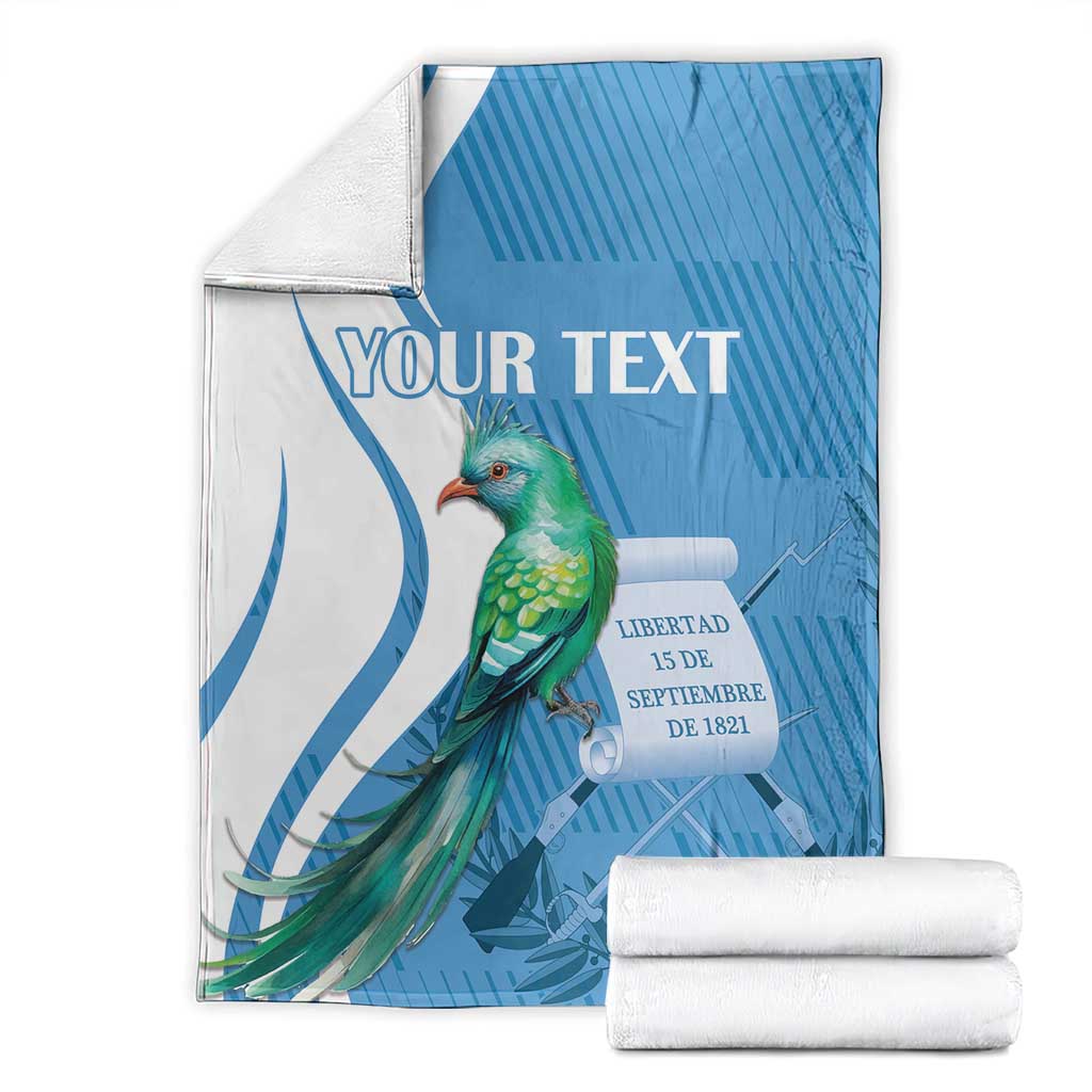 Blue and white throw blanket with quetzal bird and 'YOUR TEXT' plus folded rolls