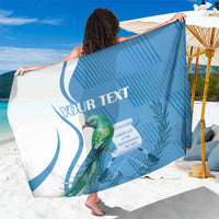 Blue personalized sarong with quetzal bird graphic and 'YOUR TEXT' panel