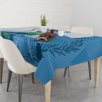 Blue Independence Day tablecloth with tropical leaf and bird print, draped on a table.