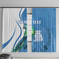 Two personalized window curtain panels side by side, white and blue with quetzal art