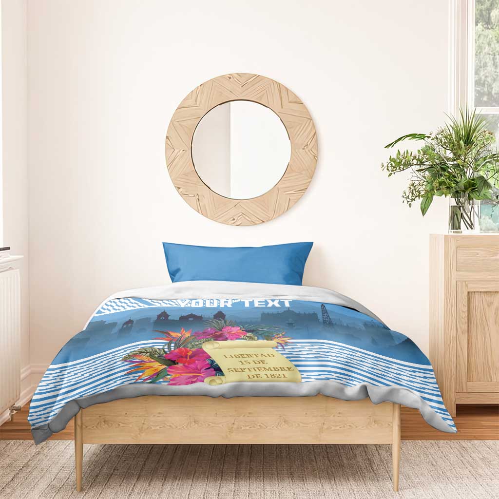 Blue duvet and pillow set with tropical floral design, stripes, and custom text banner