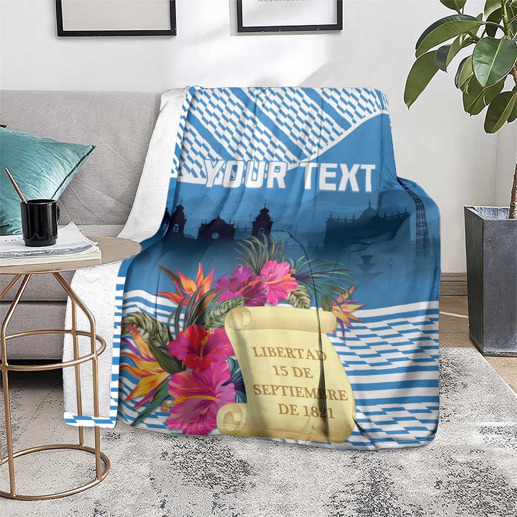 Personalized Independence Day blanket draped, blue zigzag pattern with tropical blooms and “LIBERTAD”.