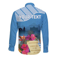 Blue long-sleeve button shirt with tropical floral independence graphic and banner