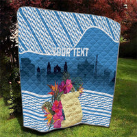 Blue quilt with tropical bouquet on grass, skyline silhouette and custom text