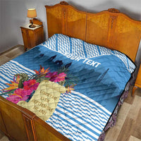 Blue quilt on wooden bed, quilted diamonds and floral accent with custom text