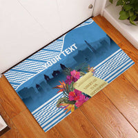 Blue rubber doormat with tropical flowers and Guatemala city skyline, customizable text