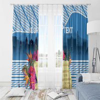 Blue window curtains on a rod with floral print and skyline silhouettes