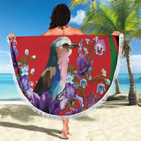 Round red beach blanket with white fringe, bird-and-flower print with multicolor border