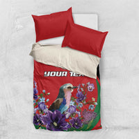 Red and green duvet bedding set with custom text and bird among violet flowers, two pillows