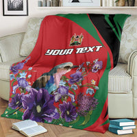 Personalized blanket close-up: custom text over bird and purple flowers on red with green/black stripes