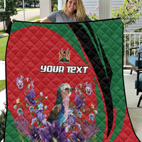 Personalized quilt with red-and-green swirl design, purple flowers, and “YOUR TEXT” in center