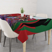 Red tablecloth with green-and-black swoops and purple floral print, draped on dining table