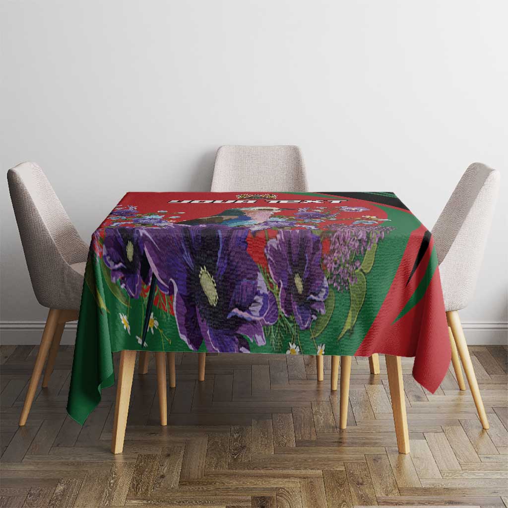 Red, green, and purple floral tablecloth on a square dining table with four chairs