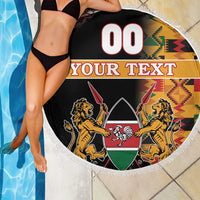 Round beach blanket with fringed edge, black lions coat of arms and Kente border