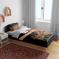 Black bedding set with Kente patterned stripe and Harambe crest graphic on duvet
