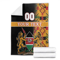 Black Kenya coat of arms blanket with folded Kente print, lion crest and HARAMBEE