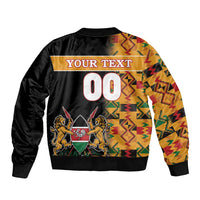 Black bomber jacket with Kente-pattern panels and central 00 emblem graphic