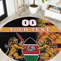 Black round carpet with Kenyan coat of arms, kente border, and “YOUR TEXT”