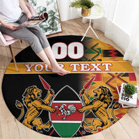 Black round carpet with lion crest and shield, kente border, and “YOUR TEXT”