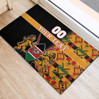 Black rubber doormat showing '00' and 'YOUR TEXT' with Kenya coat of arms and Kente