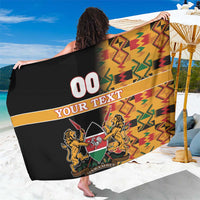 Black custom sarong with colorful kente-style zigzag pattern and crest graphic