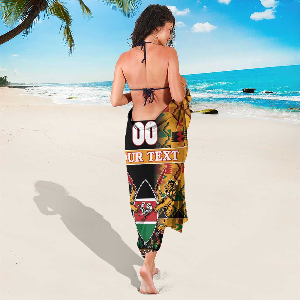 Black custom sarong with colorful kente zigzag pattern and crest graphic at center