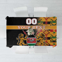 Black tablecloth with Kenya coat of arms and kente pattern, showing 'YOUR TEXT' and '00'.