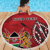Red round beach blanket with fringe edge, tribal emblem and custom text by pool.