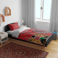 Red bedding set with duvet and two pillowcases, bold crest and circular emblem
