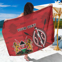 Red personalized sarong with coat of arms emblem and 'YOUR TEXT' graphic