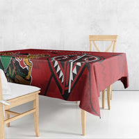 Red tablecloth with large geometric emblem and lion-figure detail