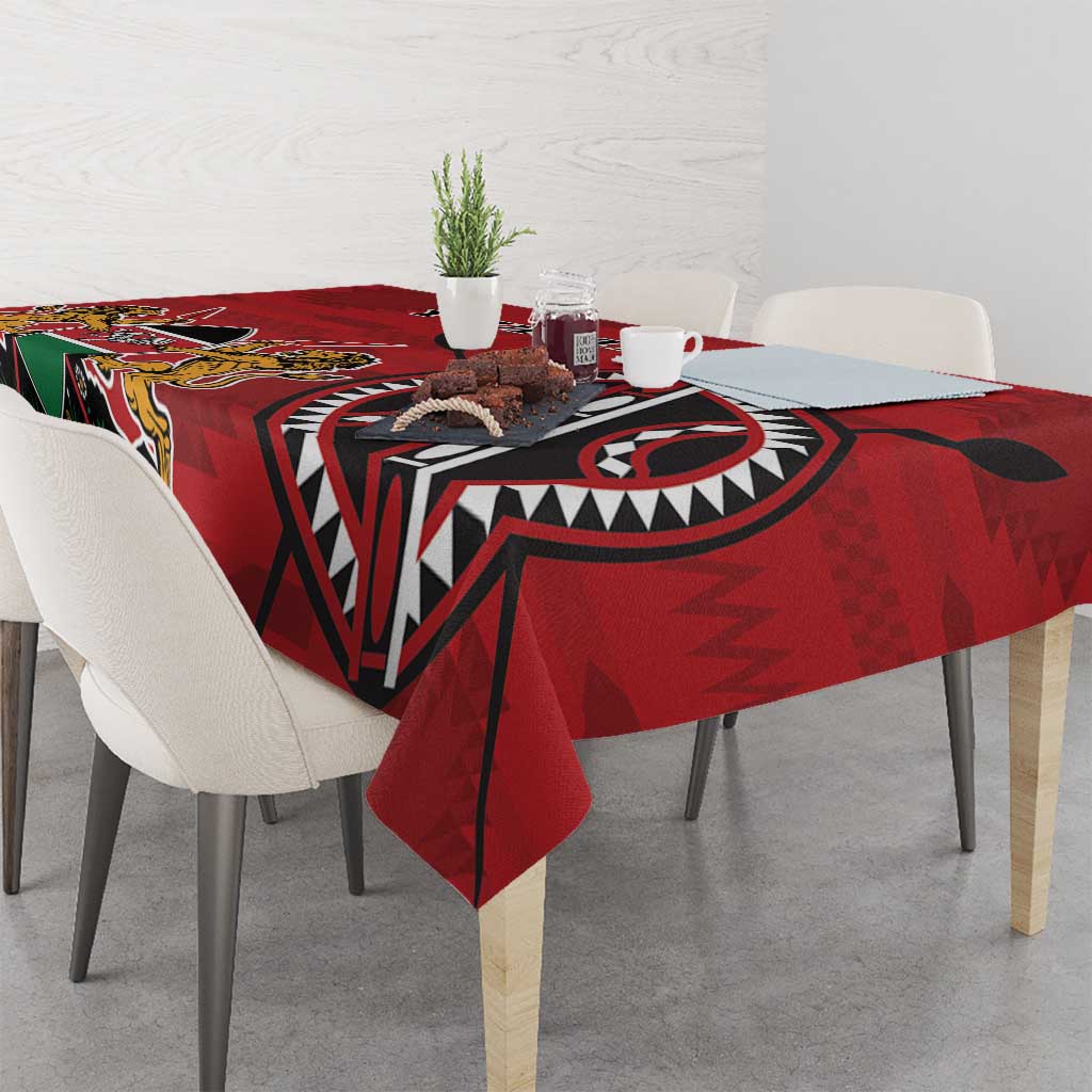 Red tablecloth with Kenya-style coat of arms and bold geometric patterns
