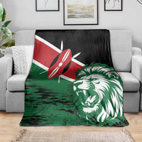 Green lion head blanket on gray sofa with red flag emblem and white lion face