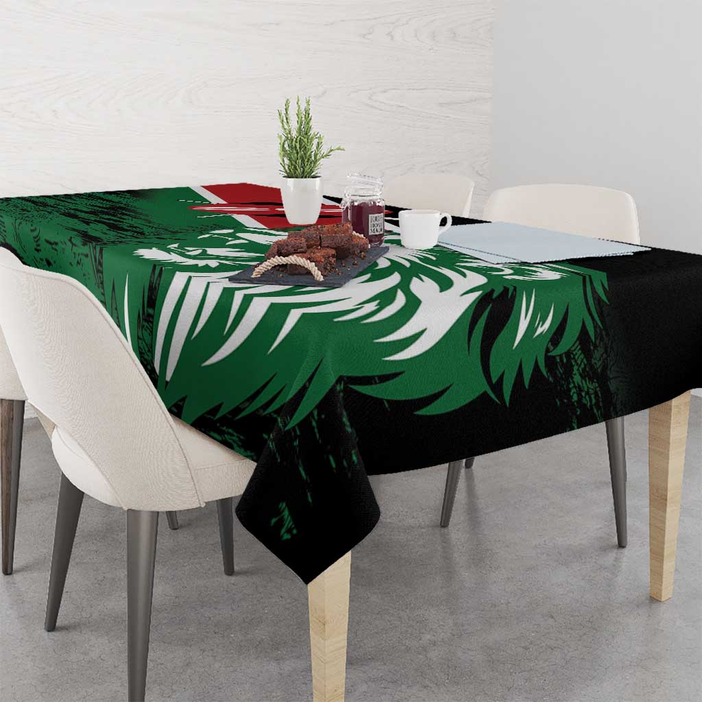 Green tablecloth with lion head and Kenya flag-style artwork, draped over dining table corners.