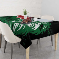 Green tablecloth with lion head and Kenya flag-style artwork, draped over dining table corners.