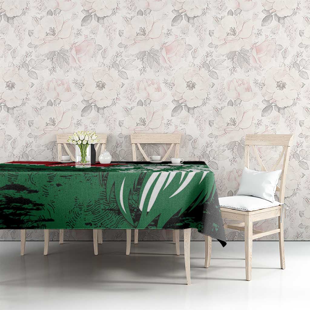 Green and black rectangular tablecloth with lion head and Kenya flag-style design on table.