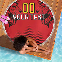 Red round beach blanket with fringed edge, lion graphics and '00' 'YOUR TEXT' print.