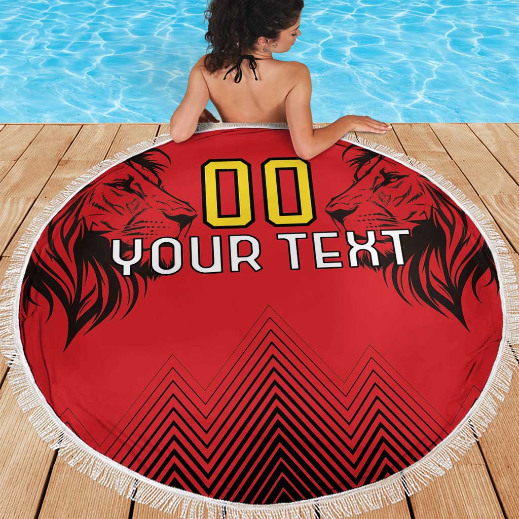 Red round beach blanket with fringed edge, lion graphics, '00' and 'YOUR TEXT' center print.