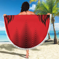 Red round beach blanket with fringed edge, bold lion print, '00' and chevron pattern.