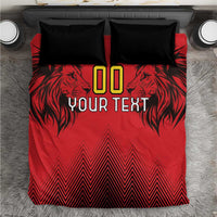 Red duvet cover with black lion graphic, geometric chevrons, and two black pillowcases