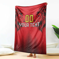 Red rugby blanket hanging on a wall with lion head graphics, “00 YOUR TEXT,” zigzag bottom